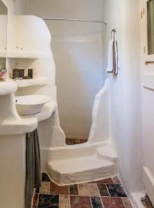 a white bathroom with a shower and a sink at Dream Boathouse in Klima