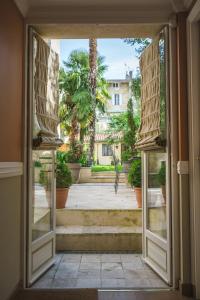 a room with a window and a large window at Villa Victor Louis - Bordeaux Centre in Bordeaux