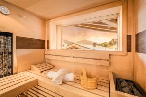 a sauna with a window and a towel at Löwen Chalets in Seefeld in Tirol