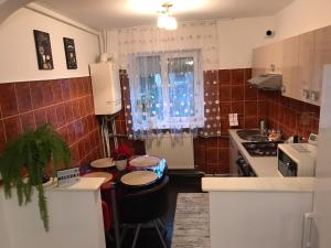 a small kitchen with a table and a sink at A3M APARTMENT in Deva +4 photos