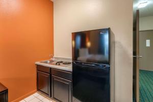 a kitchen with a black refrigerator and a sink at Econo Lodge Inn & Suites Granite City in Granite City