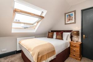 a bedroom with a bed and a window at Cappadocia Guest House in Brighton & Hove