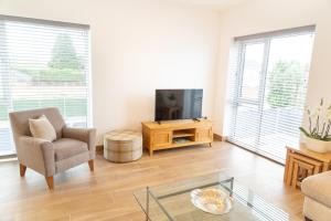 a living room with a couch and a tv at Citystay - Franklin House in Cambridge