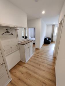 a room with white cabinets and a wooden floor at Hofstadl Sonja Liebhart in Merkenbrechts