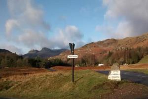 a street sign on the side of a road at Pippins, Elterwater in Chapel Stile