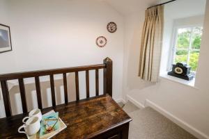 a white room with a crib and a window at Pippins, Elterwater in Chapel Stile