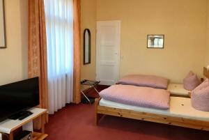 En eller flere senge i et værelse på Pension Villa Gisela