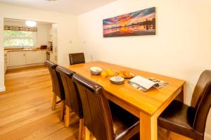 a dining room with a wooden table and chairs at Quarry Bank in Chapel Stile