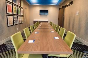 a conference room with a long table and chairs at Holiday Inn Express & Suites - Louisville N - Jeffersonville by IHG in Jeffersonville +17 photos
