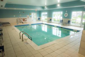 a large swimming pool in a large building at Holiday Inn Express & Suites - Louisville N - Jeffersonville, an IHG Hotel in Jeffersonville