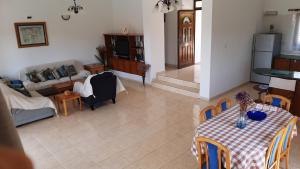 a living room with a table and a couch at Chriseleni Latchi Villas in Polis Chrysochous