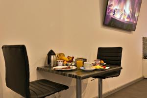 a table and two chairs with food on it at Wellness Suite Zeist in Zeist
