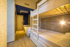 two bunk beds in a room with a hallway at Hostel Link in Lovran