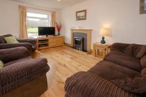 a living room with two couches and a television at 27 Thrang Brow, Chapel Stile in Chapel Stile