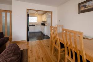 a kitchen and dining room with a table and chairs at 27 Thrang Brow, Chapel Stile in Chapel Stile