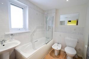 a white bathroom with a sink and a toilet at 27 Thrang Brow, Chapel Stile in Chapel Stile +3 photos