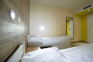 a hospital room with two beds and a mirror at Hostel Link in Lovran