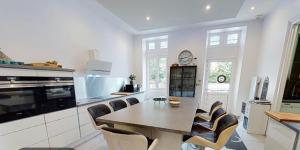 a kitchen with a table and chairs in a kitchen at Chateau Vulcain in Bernos