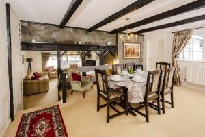 a dining room and living room with a table and chairs at Christmas Cottage in Chapel Stile