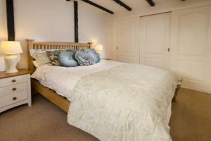 a bedroom with a large bed with blue pillows at Christmas Cottage in Chapel Stile
