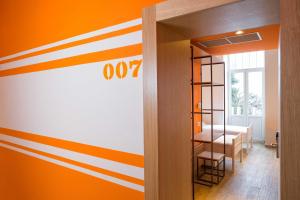 a room with orange and white stripes on the wall at Hostel Link in Lovran