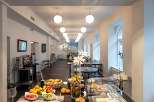 a buffet line with fruits and vegetables in a room at Cabinn Esbjerg in Esbjerg