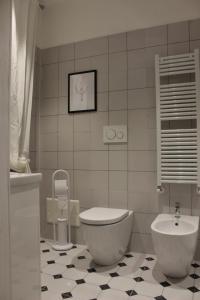 a bathroom with a tub and a toilet and a sink at MY BED affittacamere in Cuneo