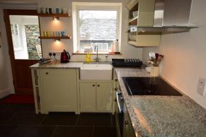 a kitchen with a sink and a counter top at Farra Grain, Little Langdale in Little Langdale