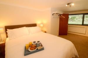 a white bed with a tray of food on it at Lingmell Fell View, Chapel Stile in Chapel Stile