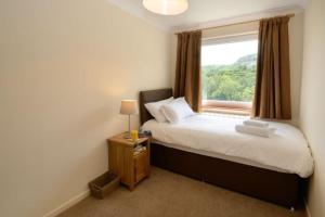 a bedroom with a large bed and a window at Lingmell Fell View, Chapel Stile in Chapel Stile