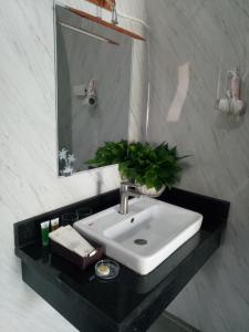 a bathroom with a sink and a mirror at Tam Coc Village Bungalow in Ninh Binh