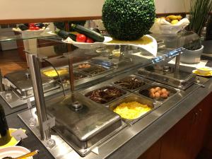 a buffet line with many different types of food at AVALON Hotelpark Königshof in Königslutter am Elm