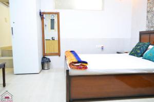 a bedroom with a bed and a door in a room at Furnished 1 Bedroom Independent Apartment 1 in Greater Kailash 1 Delhi in New Delhi