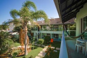 a view of the courtyard of a hotel with a palm tree at Pousada Morada da Praia in Bombinhas