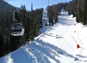a ski lift going down a snow covered slope at Appartamento Francesca in Marilleva