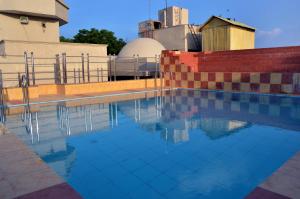 a swimming pool in front of a building at Hotel Bhoomivilas in Agra