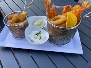 a tray with three buckets of onion rings and dips at MediTerra in Papenburg