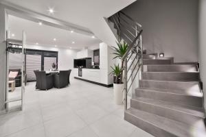 a living room with a staircase in a house at Domki Pod Lasem MM in Rabka