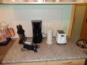 a kitchen counter with a blender and other appliances on it at Ferienwohnung Seestern Ückeritz in Ueckeritz