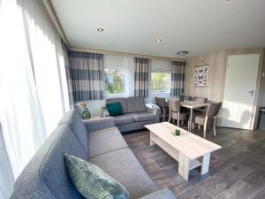 a living room with a couch and a table at Chalet OK31 Oostkapelle in Oostkapelle