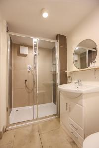 a bathroom with a shower and a sink at Hatch Street St Stephen's Green Apartments in Dublin