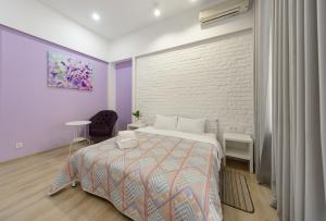 a bedroom with a bed and a brick wall at Bessarabka Apartments in Kyiv