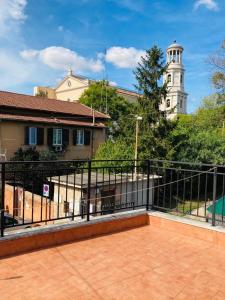 a balcony with a black fence and a clock tower at Villino Marcella in Rome