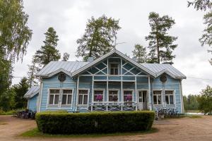 a blue house with a roof at Aurantola in Jaala