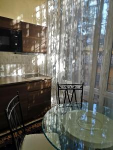 a kitchen with a glass table and two chairs at AKIRE in Rome