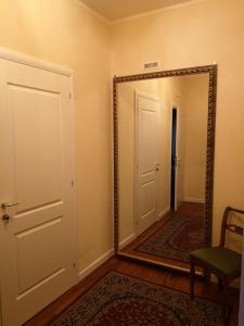 a mirror in a room with a door and a chair at AKIRE in Rome