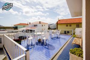 a balcony with a table and chairs on it at Beach Avenue Apartment in Ferrel