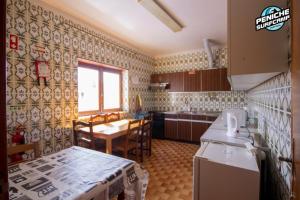 a kitchen with a refrigerator and a table in it at Beach Avenue Apartment in Ferrel