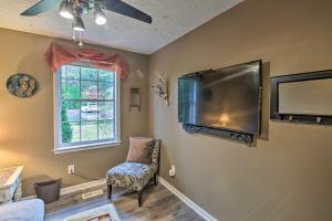 a living room with a large flat screen tv on the wall at Lively East Nashville Pad 1 Block to Dine and Shop in Nashville
