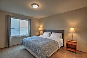 a bedroom with a bed and a large window at Birch Bay Abode Crabbing, Boating and Golfing! in Blaine